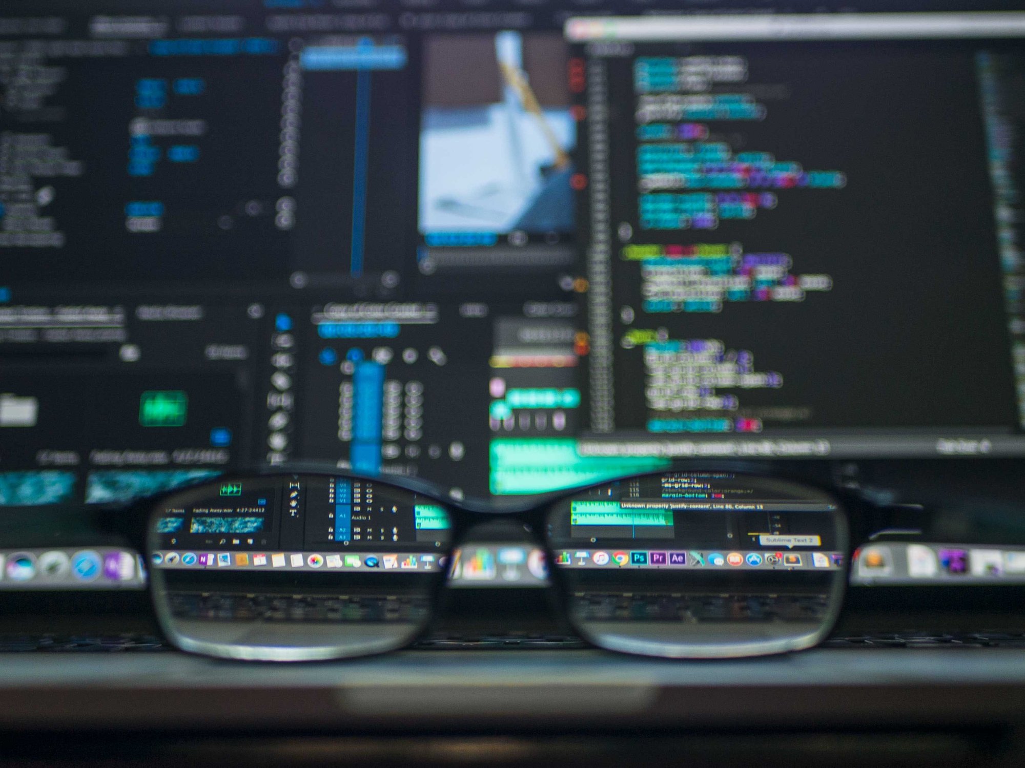 Glasses with in the background screen with code